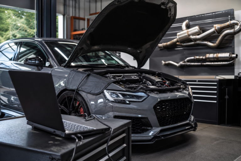 Modified car undergoing ECU and emissions-system diagnostics during the 2026 consultation